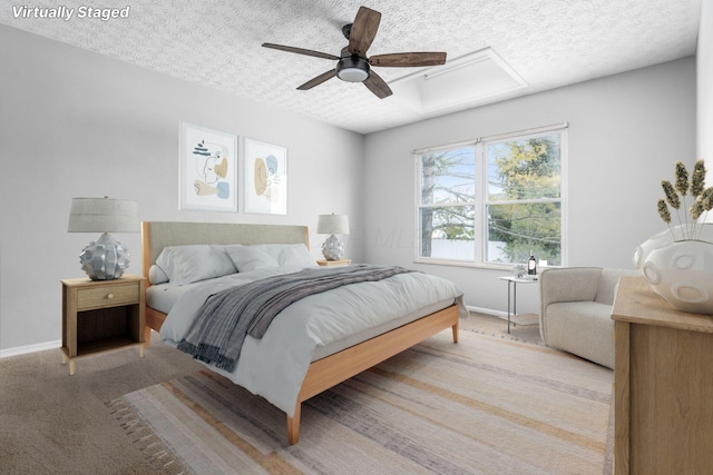 bedroom with light carpet, ceiling fan, a textured ceiling, and baseboards