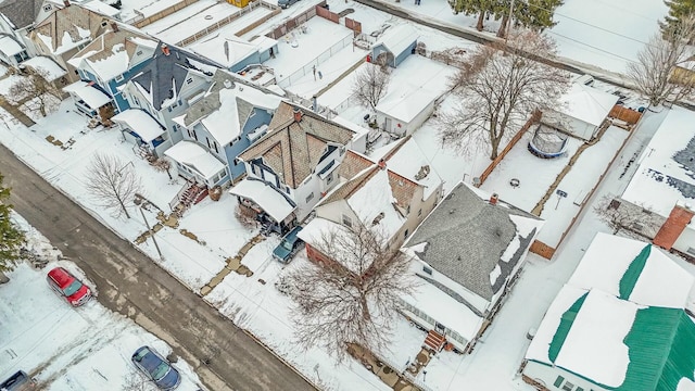 snowy aerial view featuring a residential view