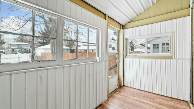 unfurnished sunroom with lofted ceiling