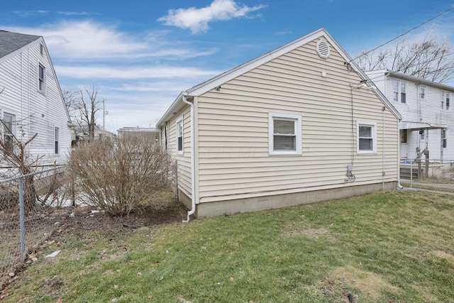 view of home's exterior featuring a yard and fence