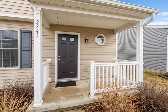 view of exterior entry featuring a porch