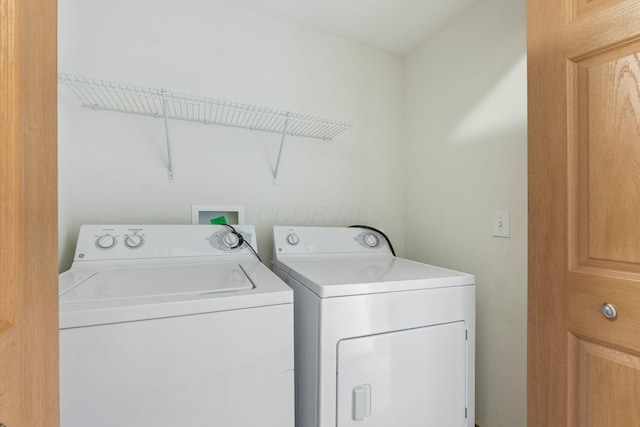 washroom featuring laundry area and washing machine and clothes dryer