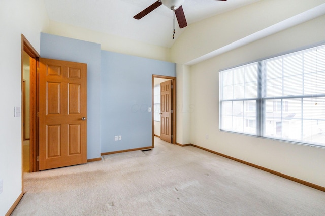 unfurnished bedroom featuring vaulted ceiling, carpet flooring, and baseboards