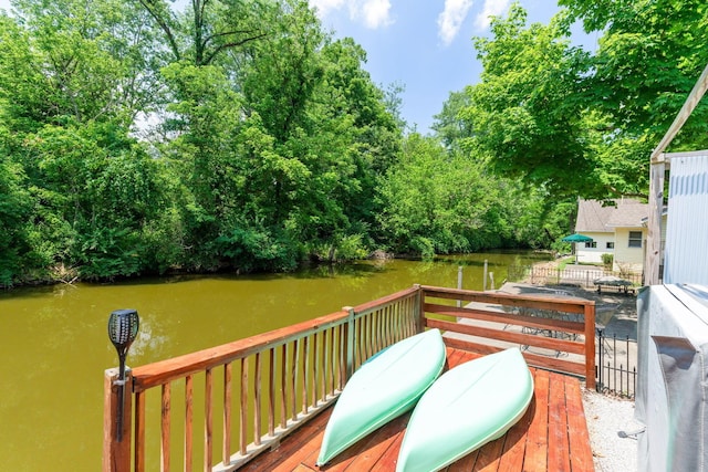 wooden terrace featuring a water view