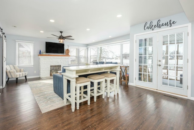 kitchen featuring a wealth of natural light, open floor plan, dark wood-style flooring, and recessed lighting