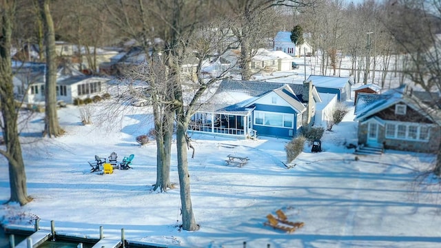 snowy yard with a sunroom