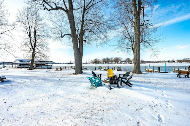 snowy yard featuring a water view