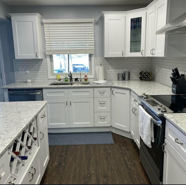 kitchen with wall chimney exhaust hood, stainless steel electric stove, and white cabinets