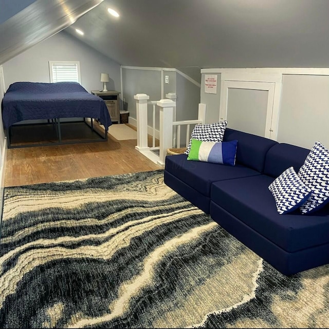 bedroom with lofted ceiling and wood finished floors