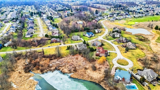 bird's eye view featuring a residential view and a water view