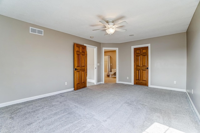 unfurnished bedroom featuring visible vents, carpet flooring, connected bathroom, ceiling fan, and baseboards