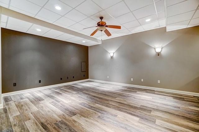 unfurnished room featuring light wood-style floors, a drop ceiling, baseboards, and a ceiling fan