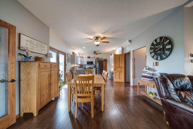 dining area featuring lofted ceiling, dark wood finished floors, and ceiling fan