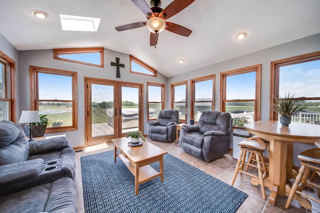 living room with french doors, lofted ceiling with skylight, and recessed lighting