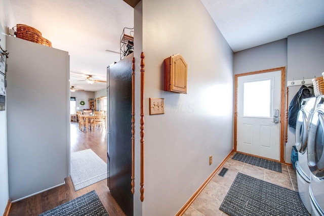 interior space with light wood-style floors, washer and dryer, visible vents, and baseboards