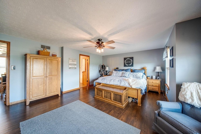 bedroom featuring a textured ceiling, dark wood-style flooring, visible vents, and baseboards