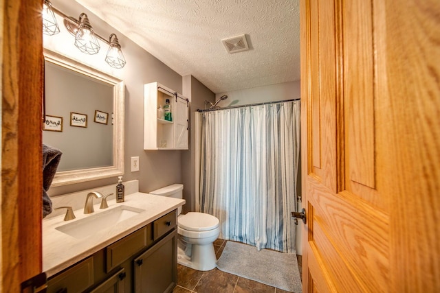 bathroom with toilet, a textured ceiling, vanity, and visible vents