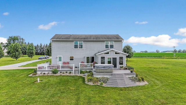 back of house with a yard and a wooden deck