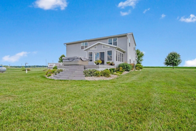 back of house featuring a yard and a deck