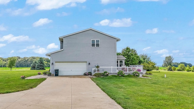 view of home's exterior featuring driveway, an attached garage, and a yard