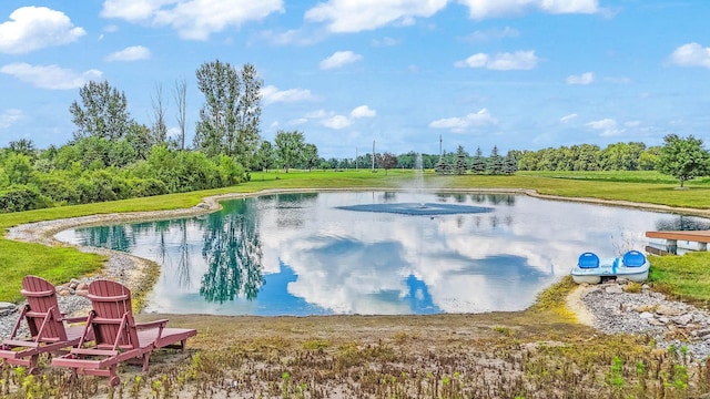 view of swimming pool featuring a water view and a yard