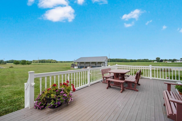 deck featuring a lawn and a rural view