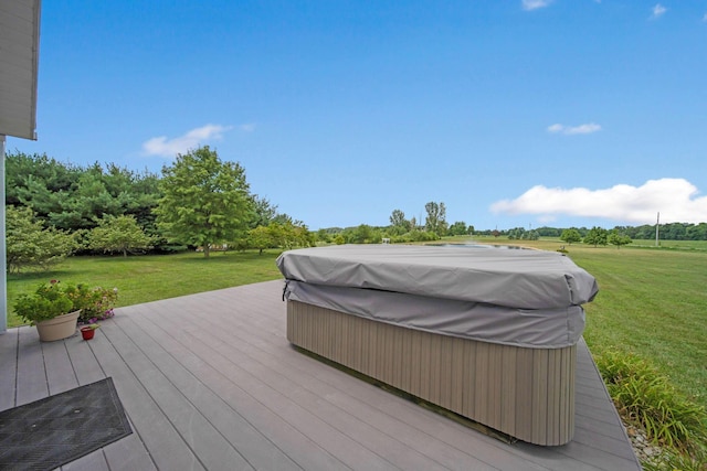 wooden deck with a yard and a covered hot tub