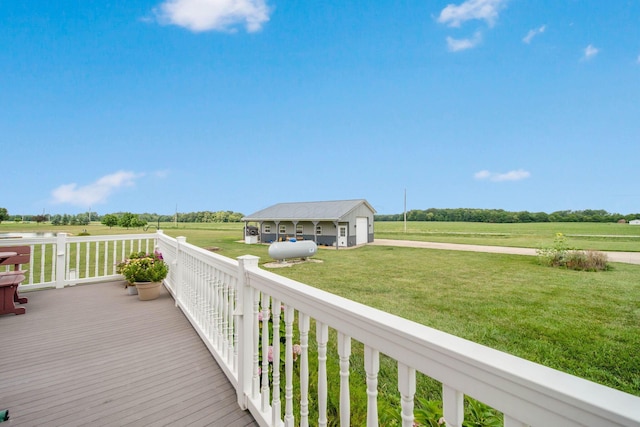 deck with a garage, a yard, and a rural view