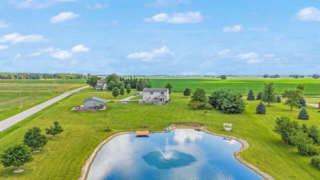 birds eye view of property featuring a rural view and a water view