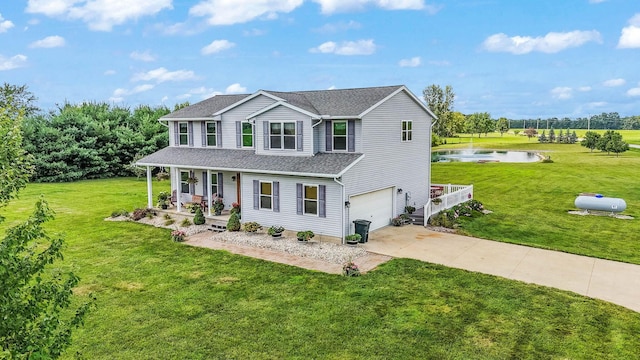 view of front facade featuring a porch, a water view, an attached garage, driveway, and a front lawn