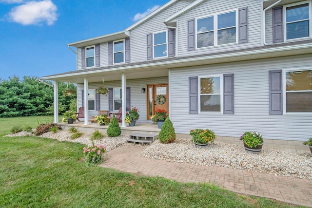 view of front of house with a front lawn and a porch