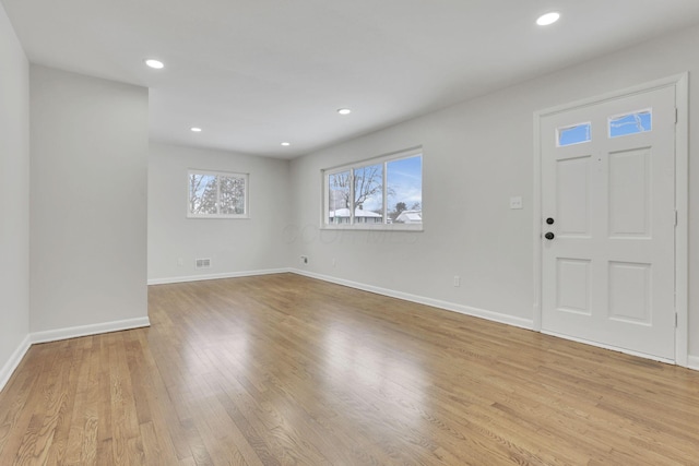 foyer with light wood-style floors, baseboards, and recessed lighting