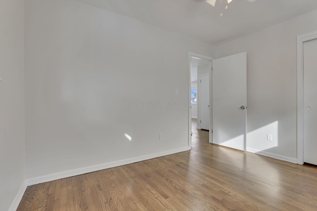 unfurnished bedroom featuring a ceiling fan, baseboards, and wood finished floors