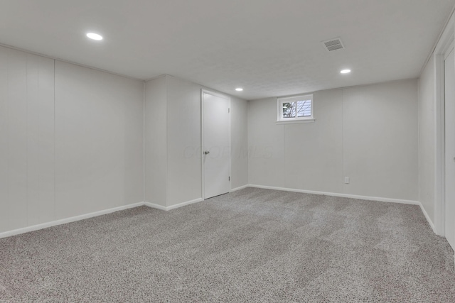 basement featuring carpet floors, visible vents, and recessed lighting