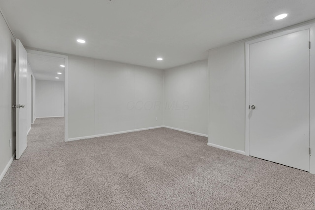 finished below grade area featuring recessed lighting, baseboards, and light colored carpet