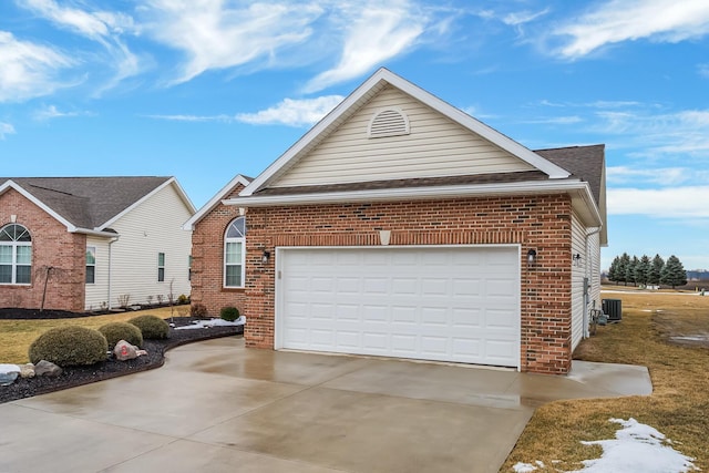 view of front of home featuring driveway, a shingled roof, an attached garage, central AC, and brick siding