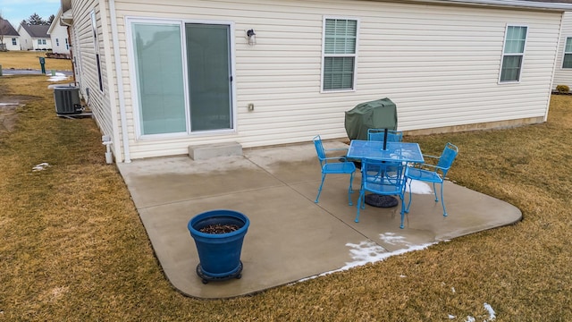 view of patio / terrace featuring outdoor dining space, area for grilling, and central AC unit