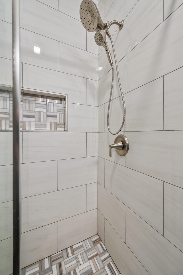 bathroom with tiled shower