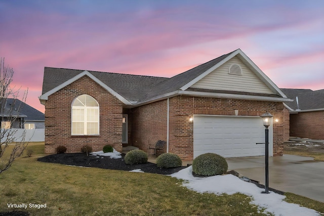 single story home featuring a garage, driveway, brick siding, and a front lawn