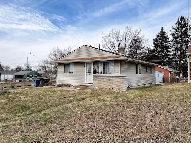 bungalow-style home with a chimney, fence, and a front yard