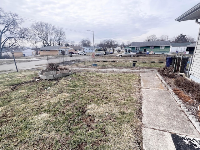 view of yard with a residential view and fence