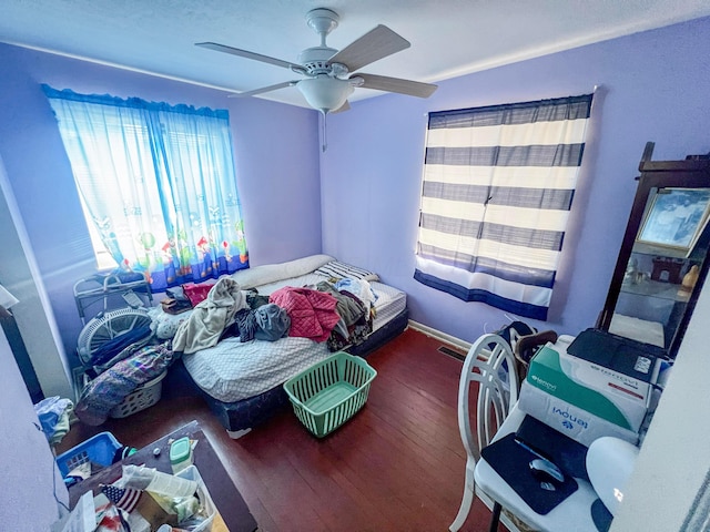 bedroom with dark wood-type flooring and a ceiling fan