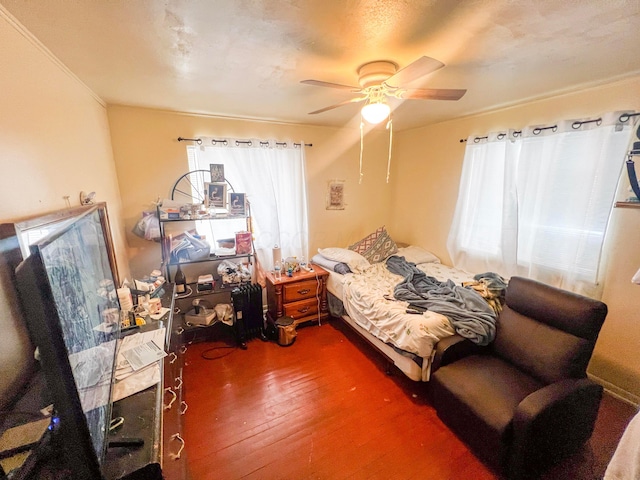 bedroom featuring a ceiling fan and wood finished floors