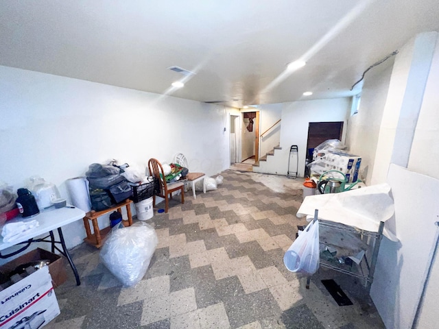 finished basement with stairs and tile patterned floors