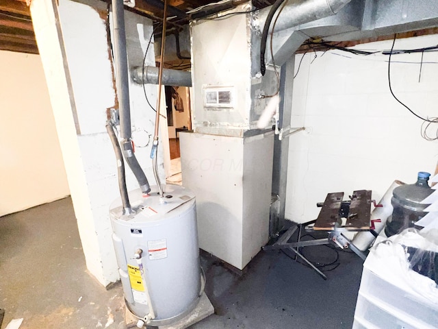 utility room featuring water heater