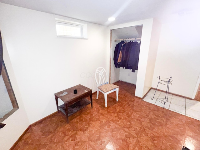 interior space featuring a closet and baseboards