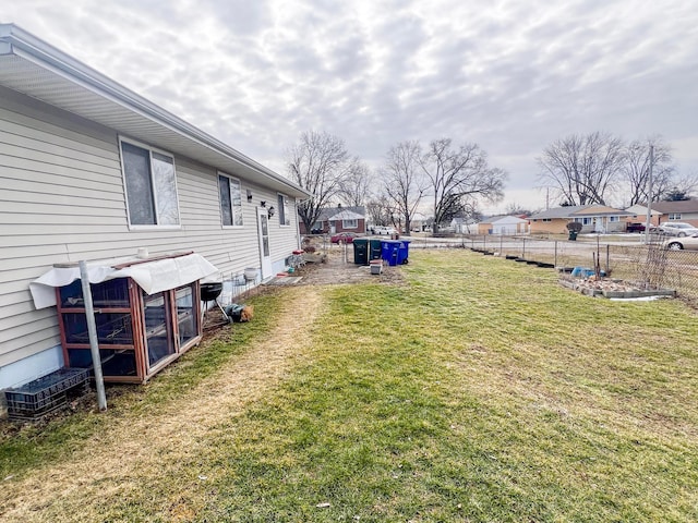 view of yard with a residential view and fence