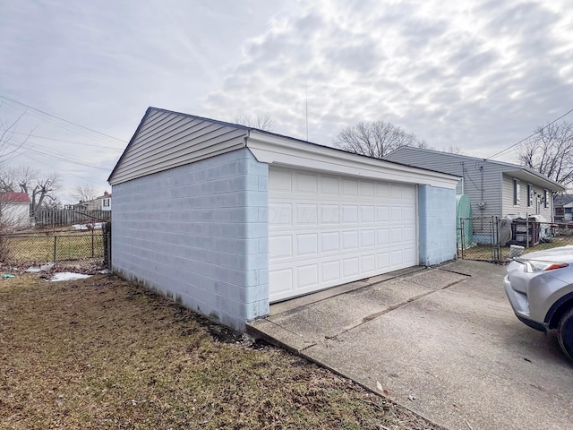 detached garage featuring fence