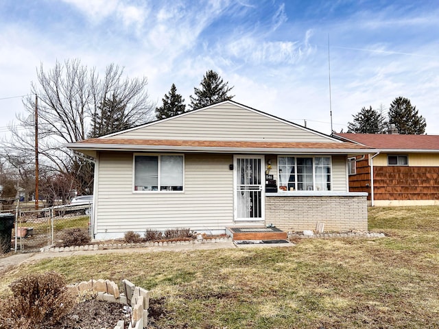 view of front of home with a front yard and fence