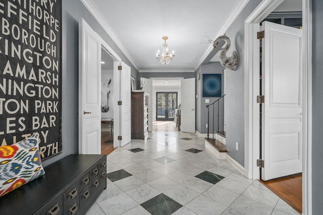 interior space with a notable chandelier, crown molding, and baseboards